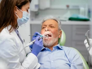 dental and medicare - dentist working on a senior